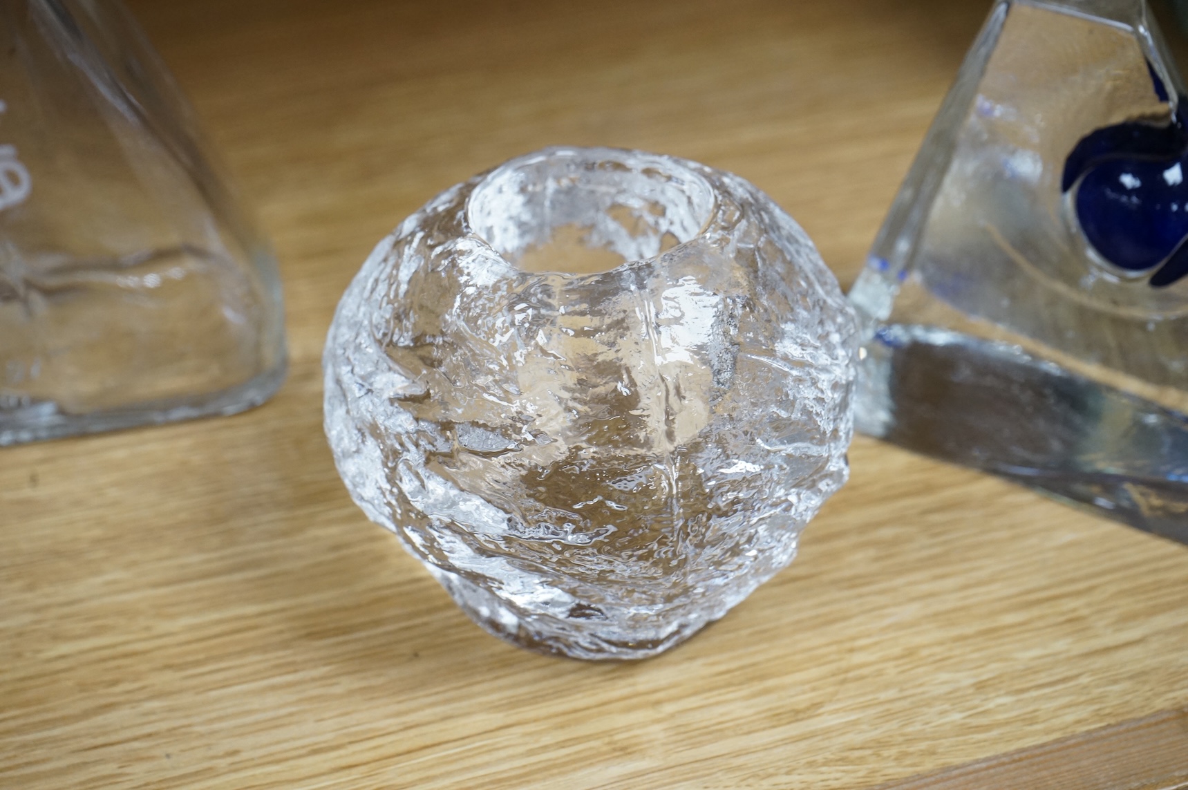 A collection of glassware including a Kosta Boda snowball pot and an Evian advertising water bottle, largest 23cm high